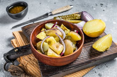 Cooking Traditional German potato salad - Kartoffelsalat. Gray background. Top view.