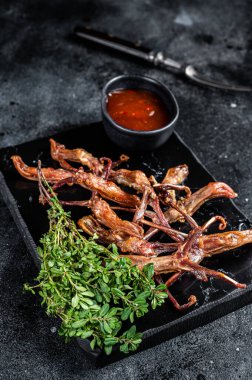 Chinese food dip fried duck tongue Black background. Top view.