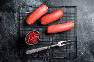 Turkish Sucuk beef meat sausage. Black background. Top view.