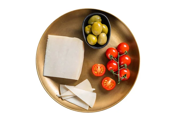 Piece of hard goat cheese in a plate with olives and tomato. Isolated on white background