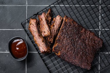 Chopped Beef Brisket barbecue, Traditional meat rubbed with spices and smoked in a Texas smoker. Black background. Top view.