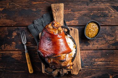 Bavarian Schweinshaxe Roast pork Hock Ham, knuckle with Sauerkraut. Wooden background. Top view.
