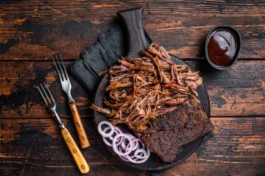 Traditional barbecue wagyu pulled beef on wooden board. Wooden background. Top view.