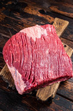 Ready for cooking beef brisket, raw meat. Wooden background. Top view.