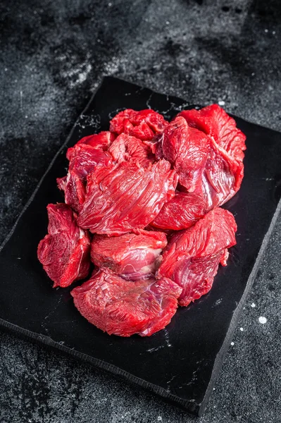 Fresh Raw diced beef veal meat for cooking Shish kebab. Black background. Top view.