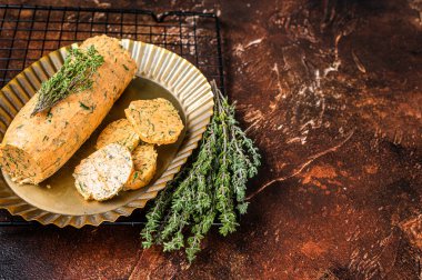 Homemade Herb Butter with thyme. Dark background. Top view. Copy space.