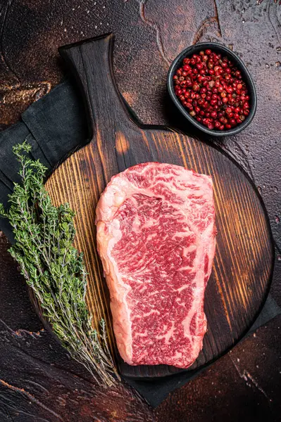 Uncooked Raw Striploin Club Steak Wooden Board Thyme Dark Background — Stockfoto