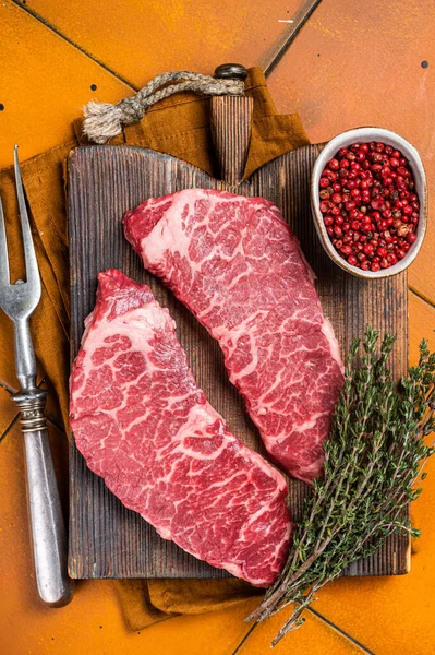 Raw Denver Beef Meat Steak Pink Pepper Thyme Orange Background —  Fotos de Stock