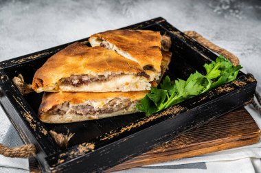 National traditional Caucasian cuisine Ossetian pie with beef meat. White background. Top view.