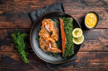 Cured Salmon fillet with dill, salt and papper, gravlax. Wooden background. Top view.