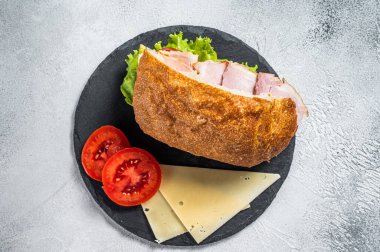 Fresh and healthy turkey sandwich with white cheese, tomato and Lettuce in white bread. White background. Top view.