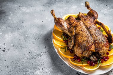 Christmas roast duck with apples and oranges, festive christmas recipe. Gray background. Top view. Copy space.