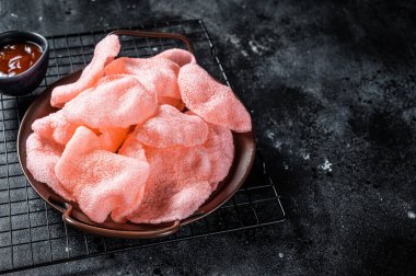 Vietnamese prawn shrimp crackers, chips, kerupuk. Asian fastfood. Black background. Top view. Copy space.