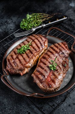 Grilled Top Blade or flat iron beef meat steaks. Black background. Top View.