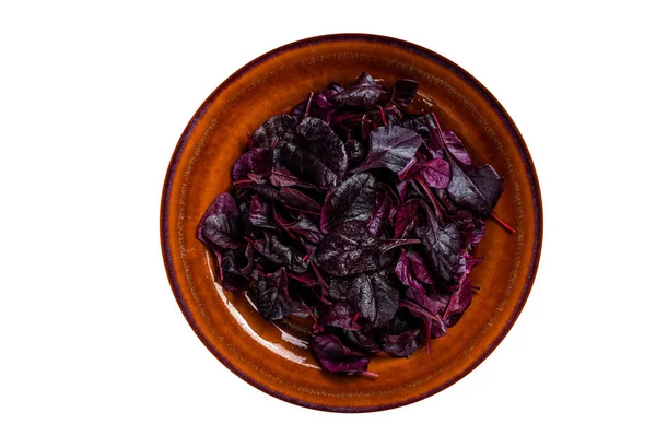 Raw Ruby or red chard salad Leafs on a rustic plate. High quality Isolate, white background