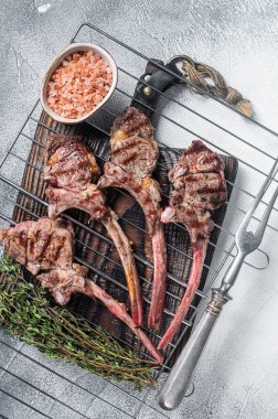 Barbecue grilled lamb meat chop on a grill, mutton rib cutlet. White background. Top view.