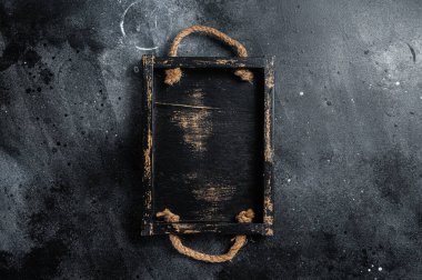 Empty rustic wood tray, healthy cooking background. Black background. Top view. Copy space.
