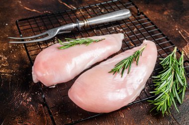 Fresh Raw chicken breast fillet, fowl meat. Dark background. Top view.