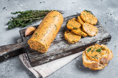 Herb Butter with Chives, Basil, Oregano, Parsley and garlic. Gray background. Top view.
