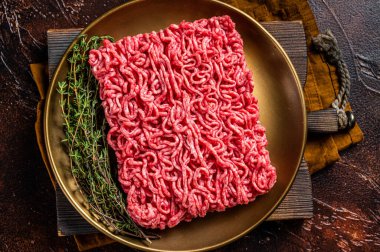 Fresh mutton lamb Mince Meat, raw ground meat. Dark background. Top view.