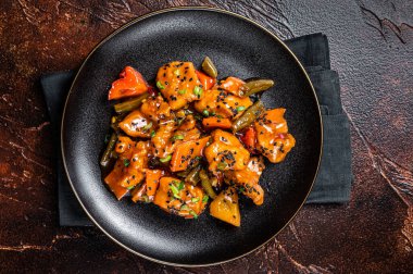 Chinese cuisine sweet and sour pork guo bao rou. Dark background. Top view.