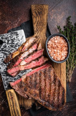 Barbecue dry aged wagyu entrecote rib eye beef steak. Dark background. Top view.