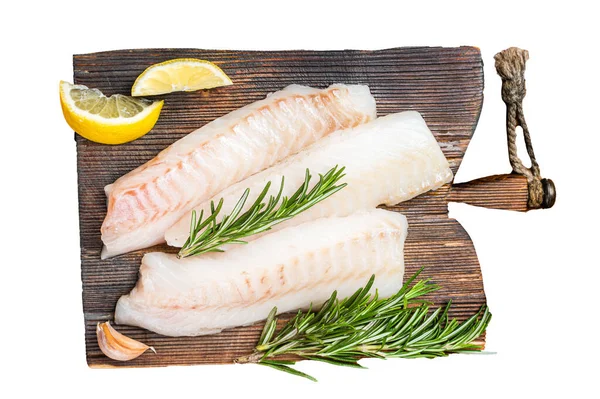 Raw cod fish fillets, codfish with rosemary on wooden board. Isolated, white background