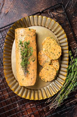 Homemade Herb Butter with thyme. Dark background. Top view.