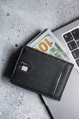 Workplace with stylish leather wallet with money, Laptop. Gray background. Top view. Copy space.