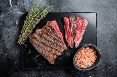 Grilled Wild Venison steak with thyme and salt, game meat. Black background. Top view.