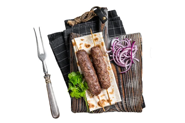 Traditional middle east kefta, kofta kebab from ground beef and lamb meat grilled on skewers served with flatbread and onion. Isolated, white background