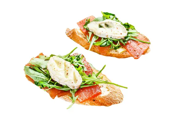 Canapes on a baguette with goat cheese, arugula and pear marmalade Isolated on white background. Top view
