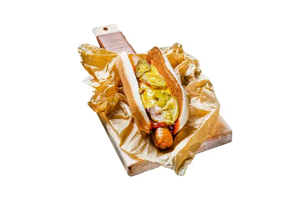 American hot dog with pork sausage on a wooden cutting Board in Kraft paper, fast food restaurant menu concept. Junk food. Isolated on white background. Top view