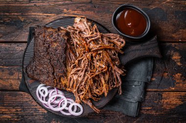 Traditional barbecue wagyu pulled beef on wooden board. Wooden background. Top view.