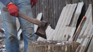 Firewood for the oven. Wood preparation. Chopping wood. Household. Cutting with an axe.