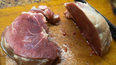 Rural cuisine. Cooking pork in a home country kitchen. Cut tenderloin for steak.