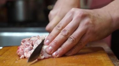 Rural cuisine. Cooking pork in a home country kitchen. Cut tenderloin for steak.