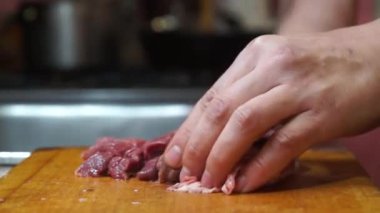 Rural cuisine. Cooking pork in a home country kitchen. Cut tenderloin for steak.