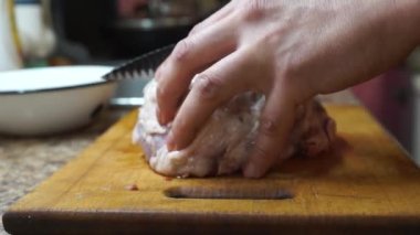 Rural cuisine. Cooking pork in a home country kitchen. Cut tenderloin for steak.