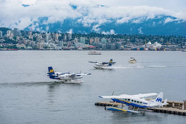 stock image Vancouver, BC- July 17, 2022: Boats and Harbour Air seaplanes in Coal Harbour with the North Vancouver, BC skyline in the background