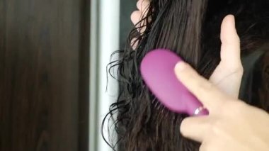woman brushing her hair after shower. High quality FullHD footage