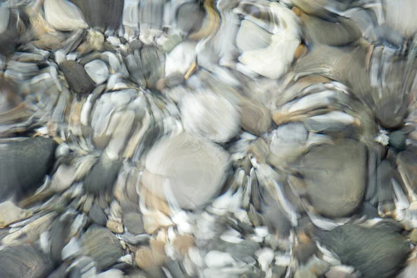 stock image Distorted stones at the bottom of a river, icm technique, intentional movement of the camera