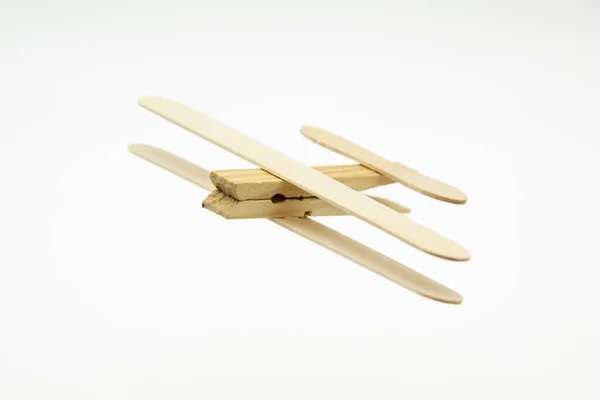 stock image Wooden plane made with ice cream sticks and a clothespin, flying over a map