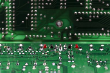 Yeşil bir elektronik levhanın birden fazla yazdırılmış devrelerinin ayrıntıları