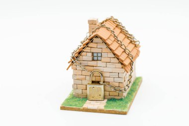 Zincirli ve asma kilitli ev, beyaz üzerine izole edilmiş.