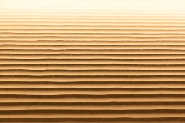 Sıcak renklerde kum gibi dalgaları olan bir duvarın dokusu