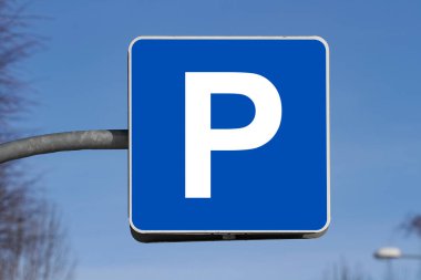 blue parking sign against blue sky