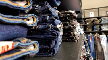 Bir Giyim Mağazasında, Denim Moda, Alışveriş ve Perakende Konsepti 'nde, Bir Rafta Giysi Askısı, Alışveriş, Moda ve Perakende Konsepti' nde kot pantolonlar sergilendi. Kaliteli fotoğraf. Kauno, Kauno m. SAv., Litvanya 04.27.2025