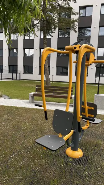 Açık hava jimnastik makinesi bir konut avlusuna kurulmuş. Göğüs ütüsü ve iniş istasyonunu birleştiriyor. Çocuk parkının yanında yer alan bu ekipman, yetişkinler ve şehir ortamlarındaki gençler için fiziksel aktiviteyi teşvik etmektedir. Bunun için uygun.