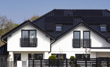 Avrupa 'da güneş panelleri olan özel bir evin çatısı. Yenilenebilir enerji kaynağı eko güneş panelleri kavramına sahip gayrimenkul.